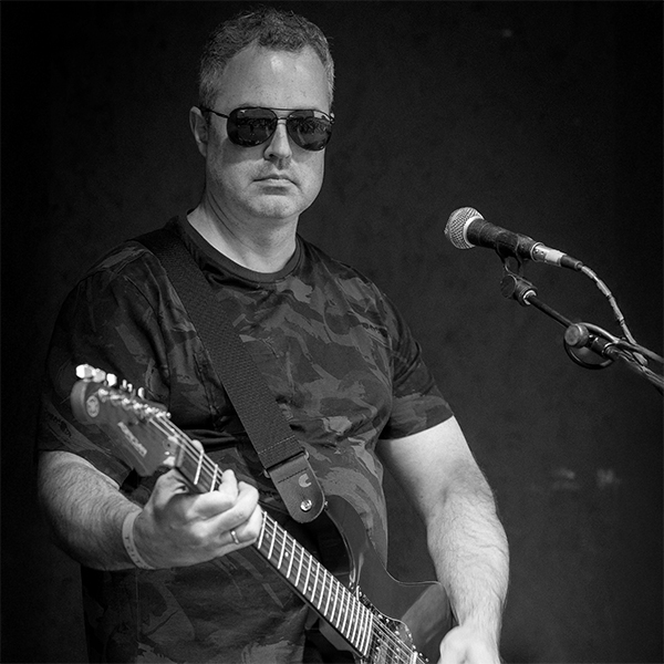 Chris Tighe Lead Guitarist and Backing Singer in One Dimensional Creatures